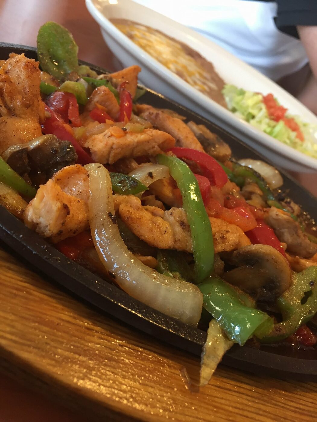 Sizzling chicken fajitas with peppers, onions and mushrooms