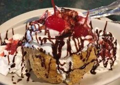 Chapala dessert topped with whipped cream, chocolate and a cherry
