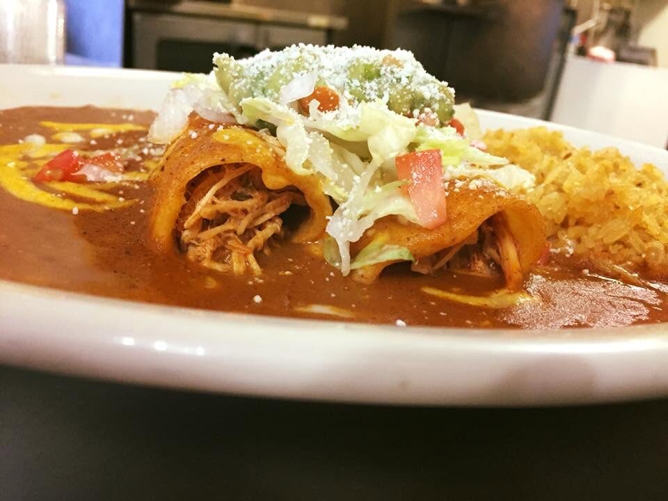 Crisp flautas topped with lettuce and guacamole