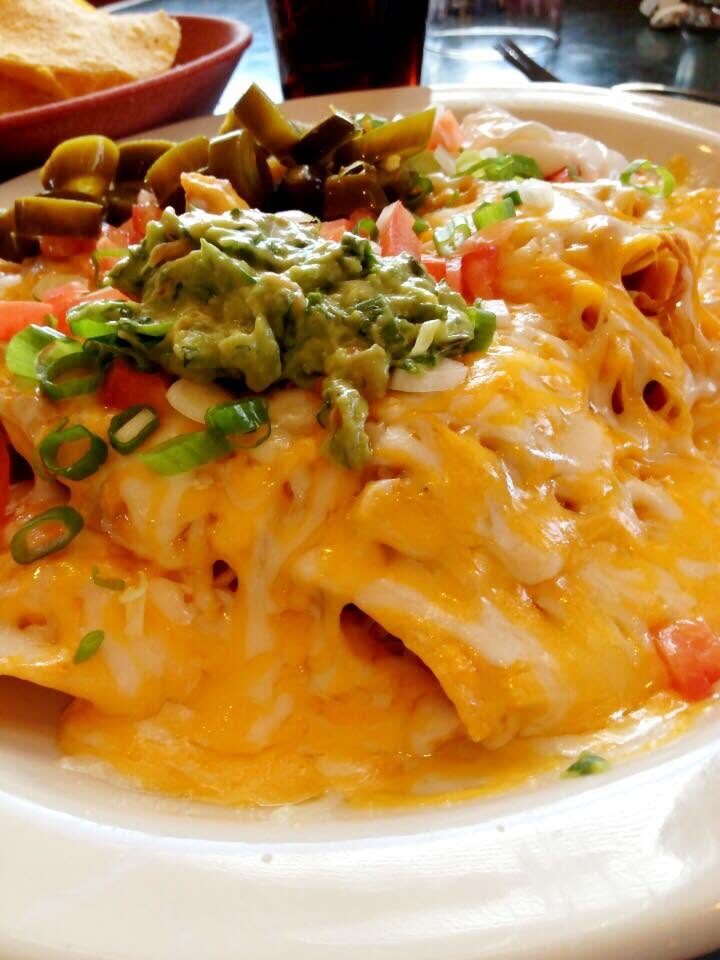 Loaded nachos covered with cheese, guacamole and jalapeños